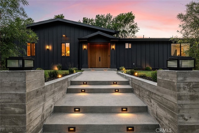 property entrance featuring board and batten siding