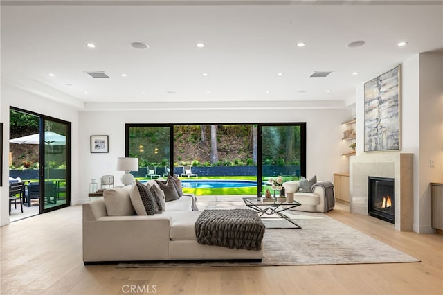 living area featuring visible vents, a wealth of natural light, and a premium fireplace
