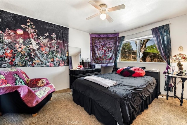 bedroom with a ceiling fan and carpet