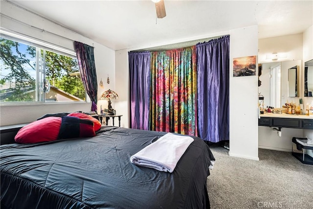 carpeted bedroom featuring baseboards, ceiling fan, and connected bathroom