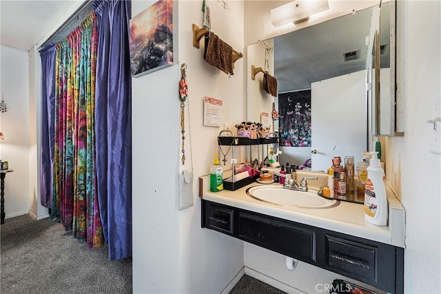 bathroom featuring baseboards, a sink, and visible vents