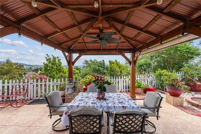 view of patio / terrace with a gazebo, fence, and outdoor dining area