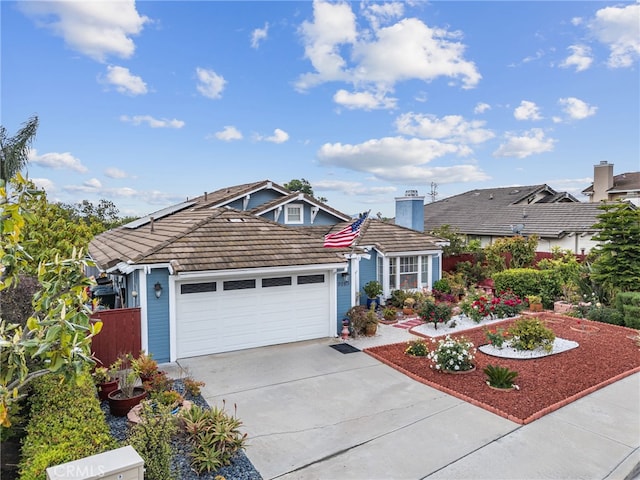 view of front of property featuring concrete driveway, a tiled roof, an attached garage, and fence