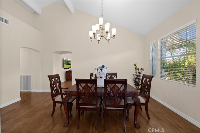 dining space with visible vents, arched walkways, wood finished floors, baseboards, and an inviting chandelier
