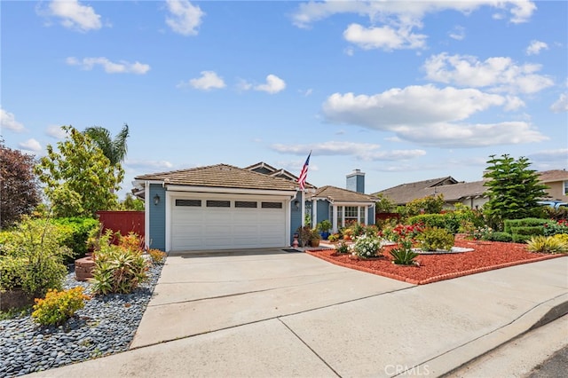 ranch-style home featuring a garage, fence, concrete driveway, and a tile roof
