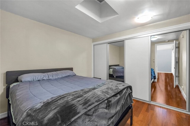 bedroom with a closet and wood finished floors