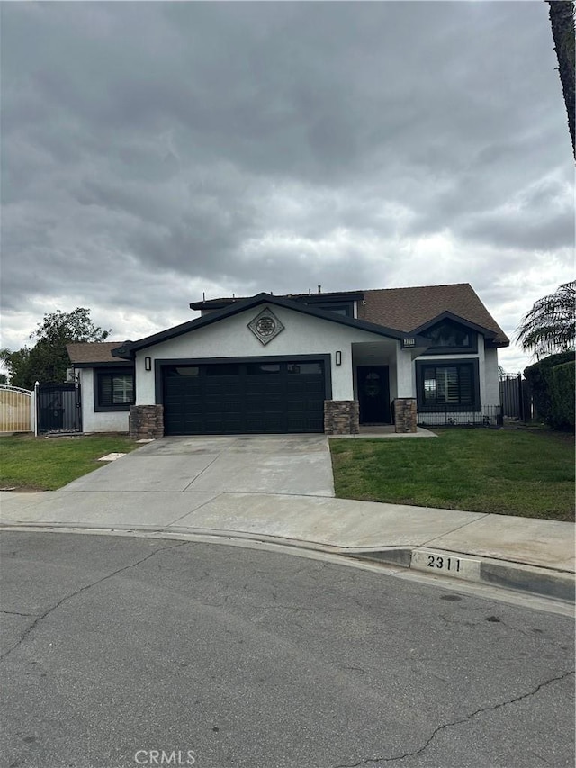 view of front facade with an attached garage, stucco siding, stone siding, and fence