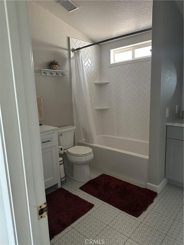 bathroom with a textured ceiling, visible vents, shower / bath combo, vanity, and toilet