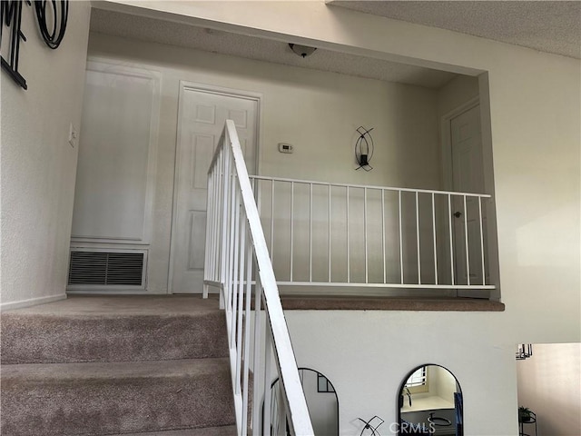 stairs with carpet and visible vents