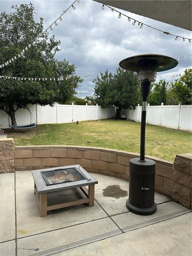 view of patio / terrace with a fenced backyard and an outdoor fire pit