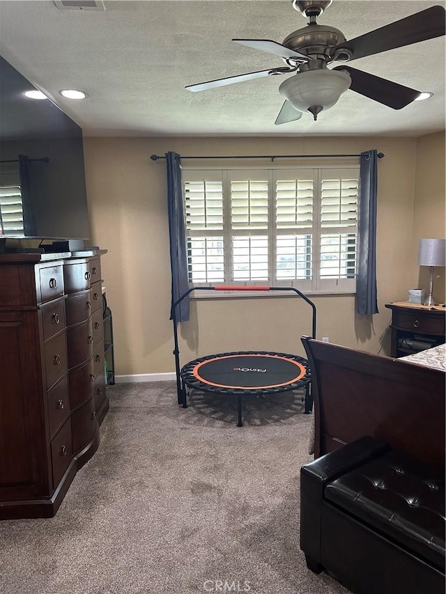 bedroom with baseboards, carpet, ceiling fan, and multiple windows