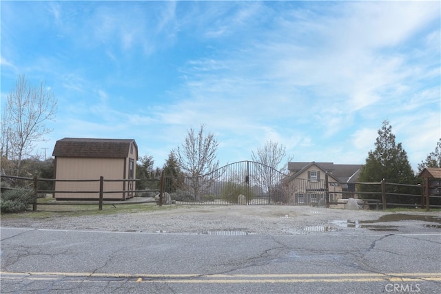 view of street featuring a gate and driveway