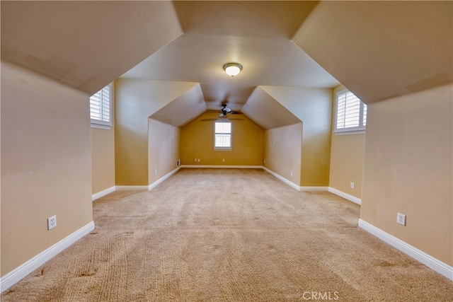 bonus room featuring carpet floors, baseboards, and lofted ceiling