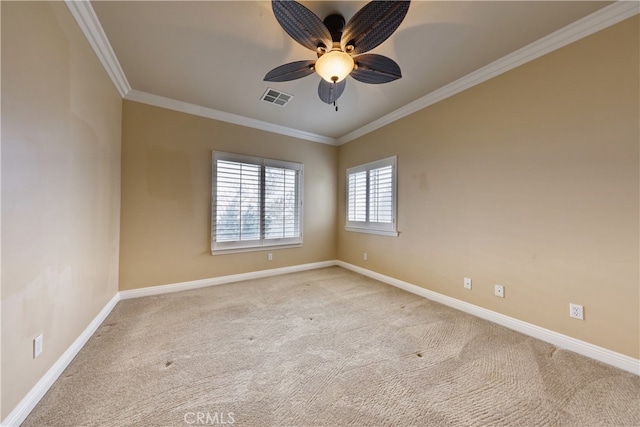 empty room featuring light colored carpet, baseboards, visible vents, and ornamental molding