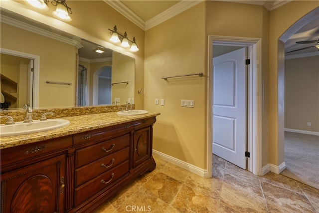 full bathroom featuring crown molding, double vanity, and a sink