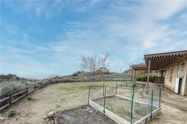 view of yard with a garden and fence