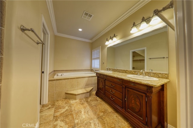 bathroom featuring visible vents, a sink, a garden tub, and ornamental molding