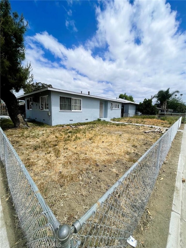 view of front facade with a fenced backyard and stucco siding