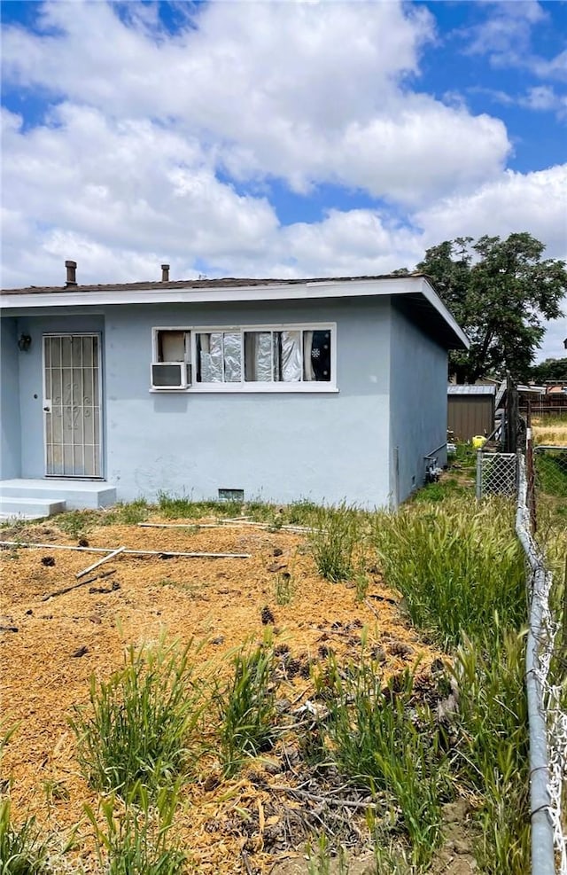 view of front of home featuring fence and stucco siding