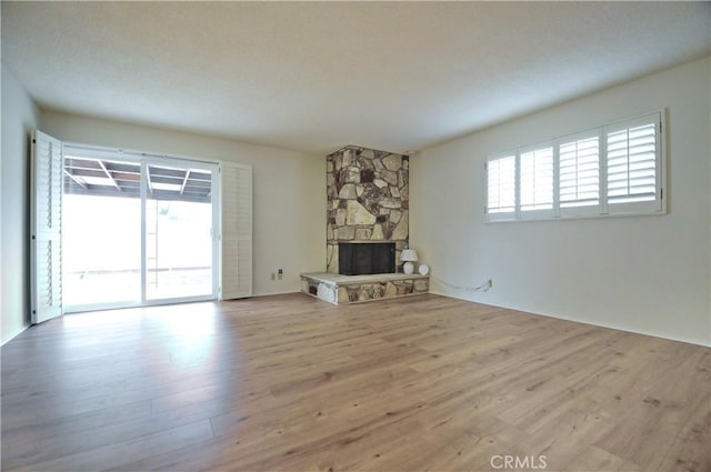 unfurnished living room featuring wood finished floors and a fireplace