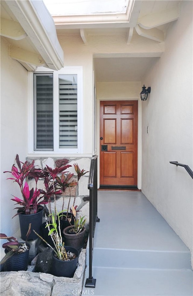 doorway to property with stucco siding