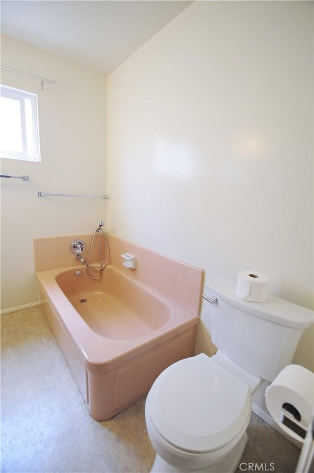 full bath with toilet and a garden tub