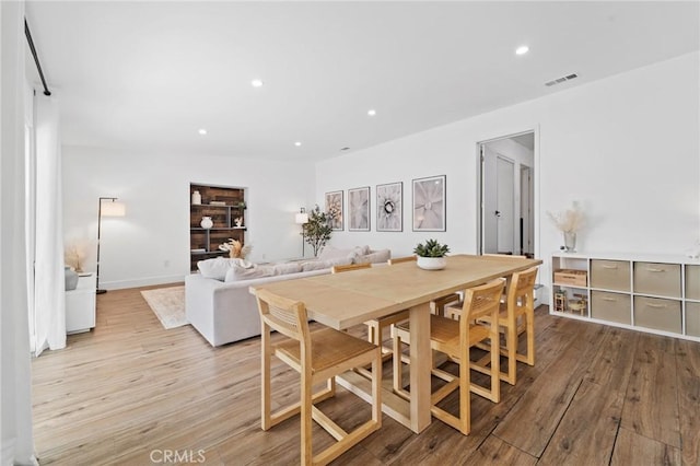 dining room with visible vents, recessed lighting, light wood-style floors, and baseboards