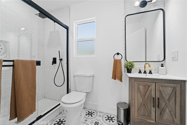full bathroom with tile patterned flooring, vanity, toilet, baseboards, and a stall shower