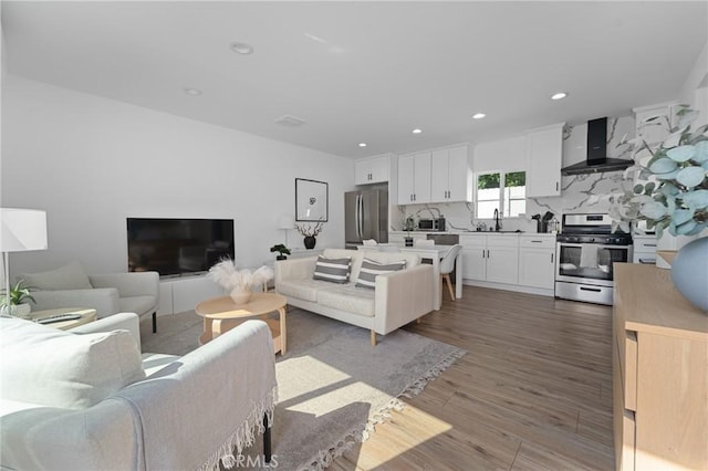 living room featuring recessed lighting and light wood-style flooring