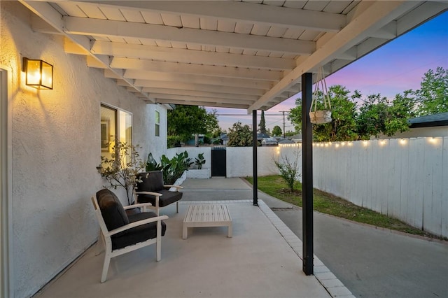 patio terrace at dusk with a fenced backyard