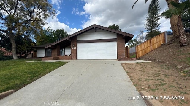 ranch-style home featuring fence, brick siding, a garage, a front yard, and concrete driveway