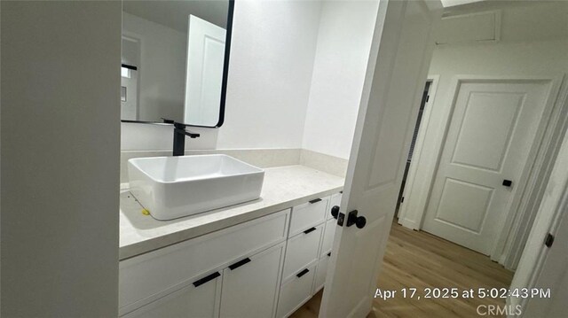 bathroom with vanity and wood finished floors