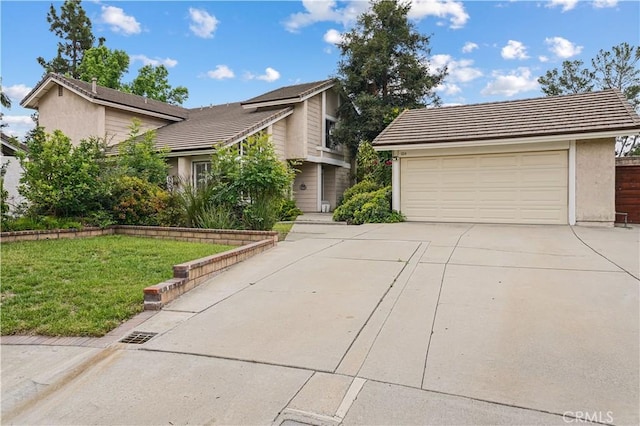 view of front of house featuring a garage, stucco siding, concrete driveway, and a front lawn