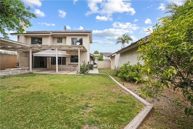 rear view of property featuring a pergola, a fenced backyard, stucco siding, a patio area, and a lawn