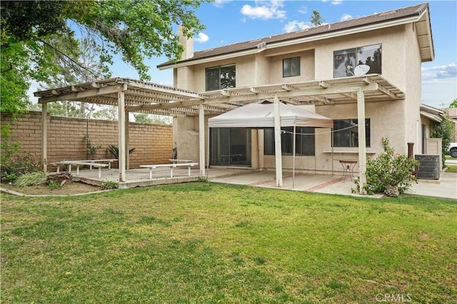back of house featuring fence, a pergola, stucco siding, central air condition unit, and a patio