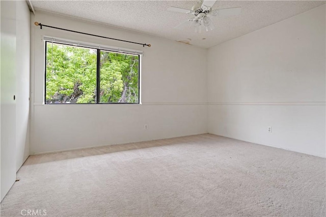carpeted spare room with a textured ceiling and ceiling fan