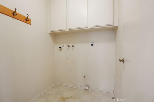 laundry room with cabinet space, hookup for a washing machine, baseboards, electric dryer hookup, and light floors