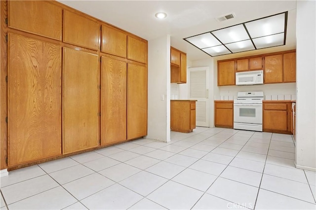 kitchen featuring brown cabinets, white appliances, light countertops, recessed lighting, and visible vents