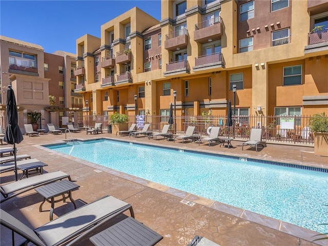 pool with fence and a patio area