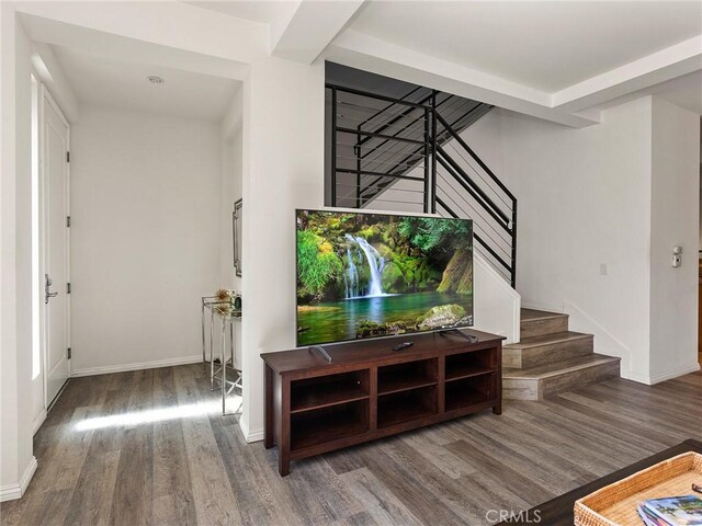 interior space featuring baseboards, wood finished floors, and stairway