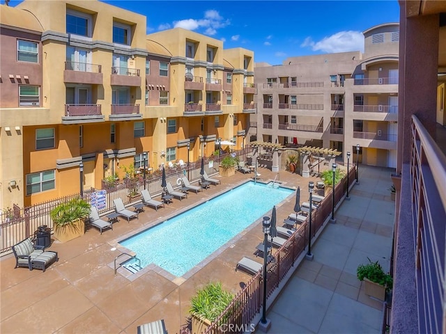 pool with fence and a patio area