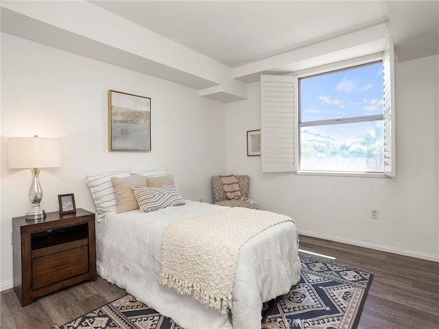 bedroom with baseboards and dark wood finished floors