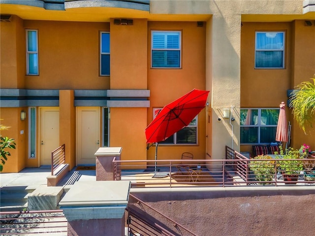 back of property featuring stucco siding and a balcony