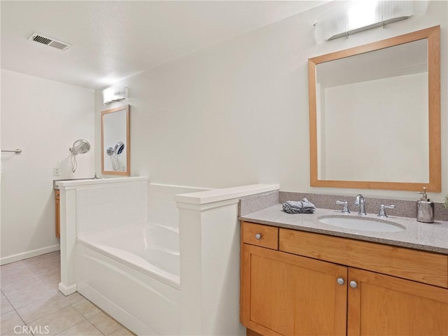 full bath featuring vanity, tile patterned flooring, a garden tub, and visible vents