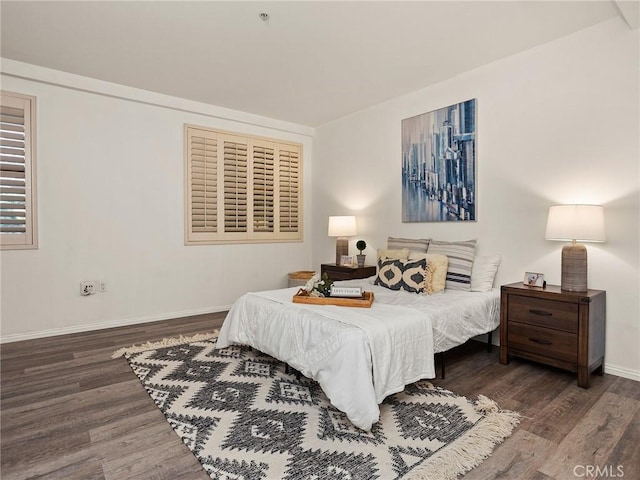 bedroom with baseboards and wood finished floors