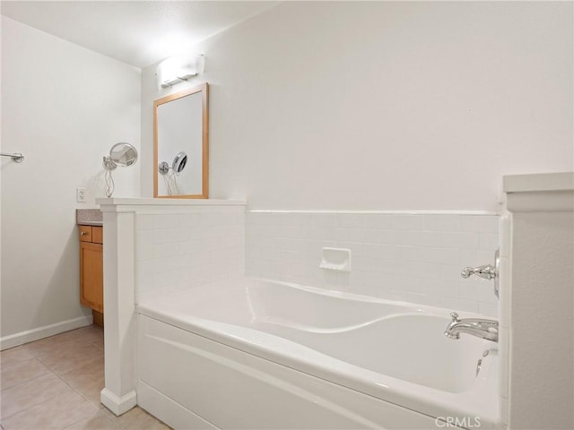 full bath with baseboards, tile patterned flooring, a bath, and vanity