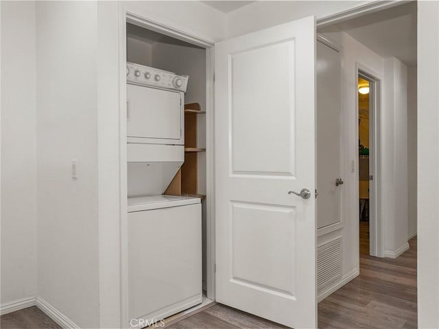 closet featuring stacked washer and dryer and visible vents