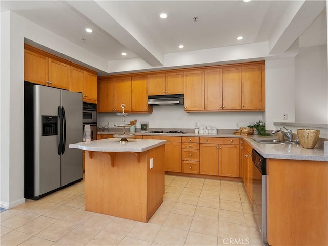 kitchen with a kitchen breakfast bar, appliances with stainless steel finishes, a sink, light countertops, and under cabinet range hood