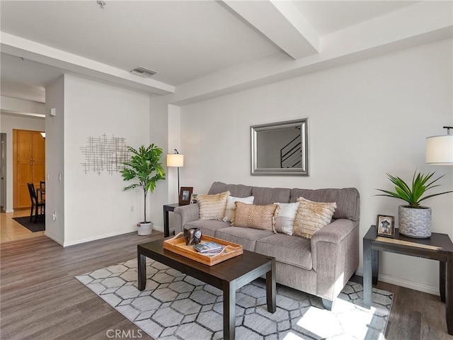living area featuring baseboards and wood finished floors