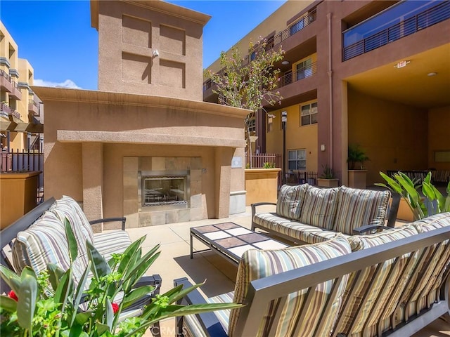 view of patio featuring an outdoor living space with a fireplace